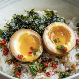 mayak eggs (drug eggs) showing jammy yolks on rice with roasted seaweed