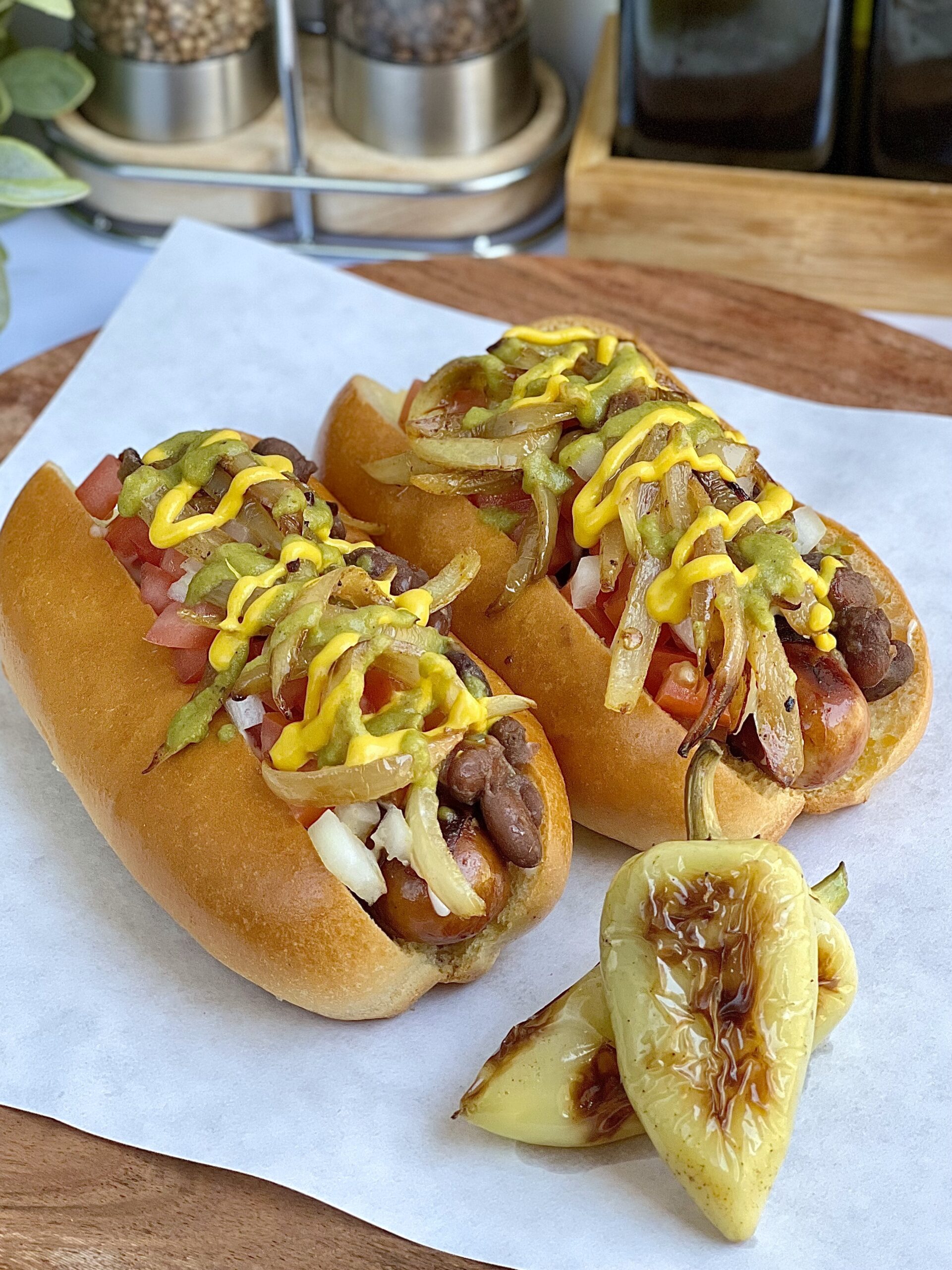 Sonoran style hot dogs topped with mayo, lime juice, pinto beans, jalapeno, onions and tomatoes