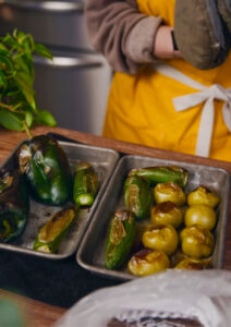 trays of roasted green peppers and tomatillos