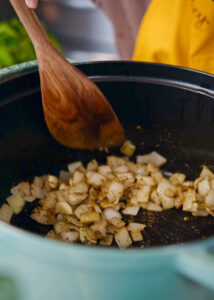 diced onions, garlic, and seasonings being sauteed for 20 seconds.