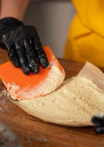 spreading masa onto a corn husk