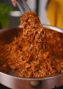 Succulent shredded pork meat in a salsa roja