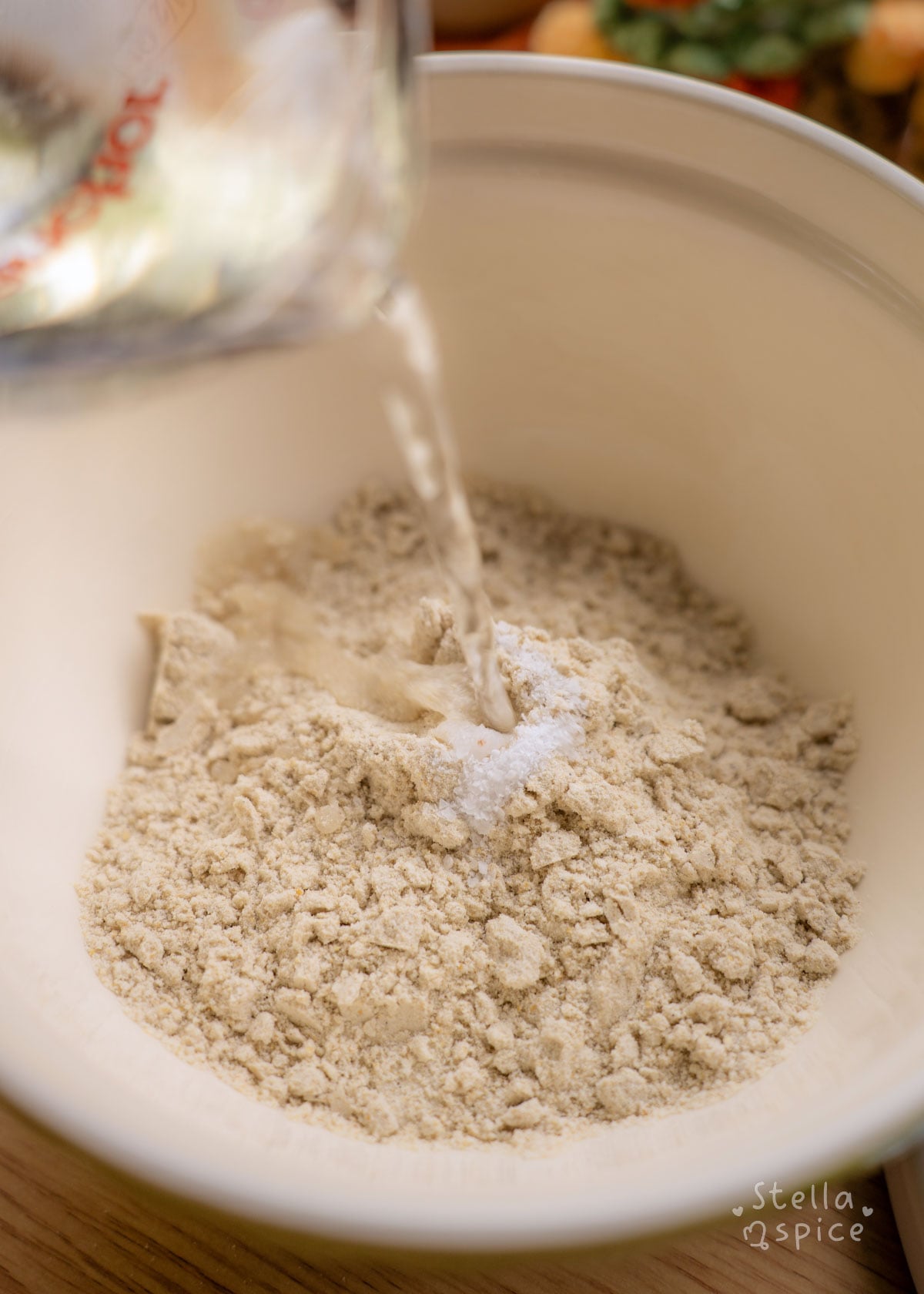 masa harina, salt, and warm water combined in a bowl.