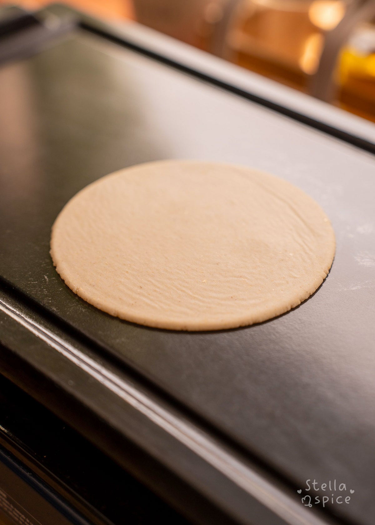 uncooked corn tortilla on griddle for 15 seconds on first side