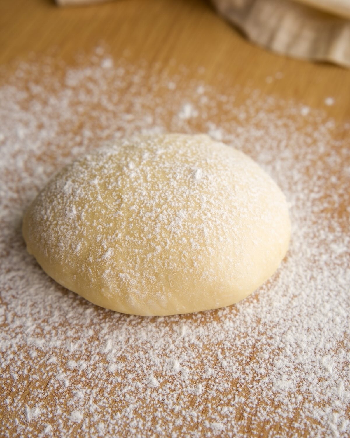 step 1: lightly flour your work surface, place the dough on top and lightly flour the top of the dough.