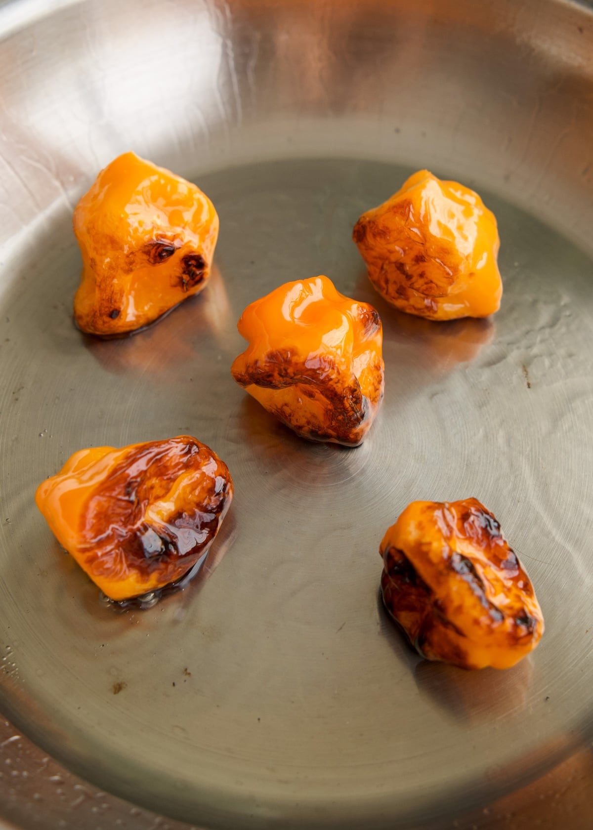 habaneros blistered in a pan of oil