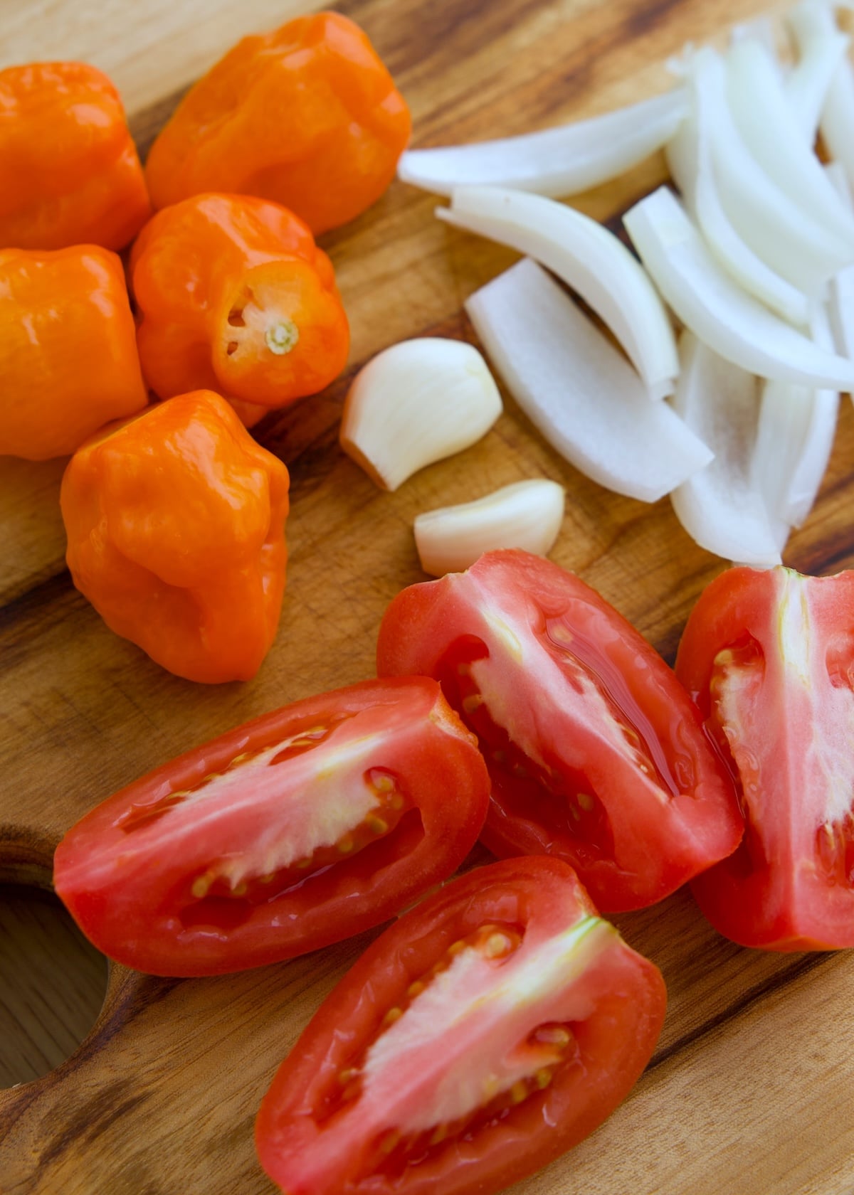 ingredients prepped (tomatoes cut, stems cut off habanero, onions sliced)